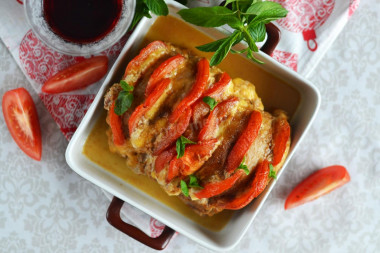 Pork accordion in the oven in foil with tomatoes