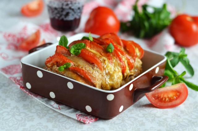 Pork accordion in the oven in foil with tomatoes