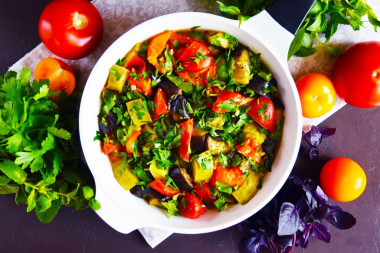 Zucchini with eggplant and tomatoes in a frying pan