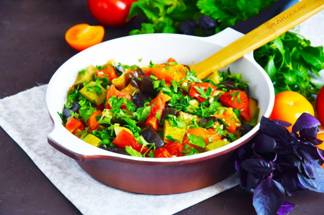 Zucchini with eggplant and tomatoes in a frying pan