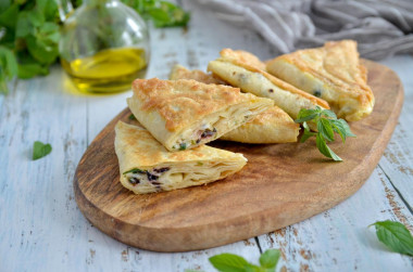 Pita bread pies with cheese in a frying pan