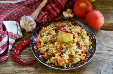 Pilaf in a cauldron on a fire of mutton