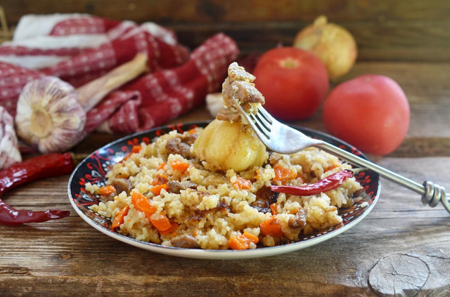 Pilaf in a cauldron on a fire of mutton