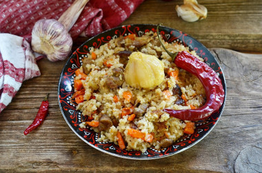 Pilaf in a cauldron on a fire of mutton