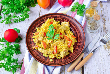 Pilaf with turkey in a frying pan