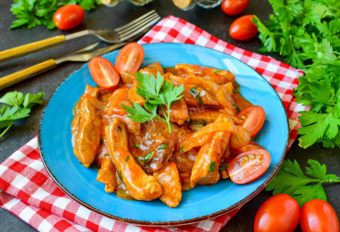 Pork meat in tomato sauce in a frying pan stewed