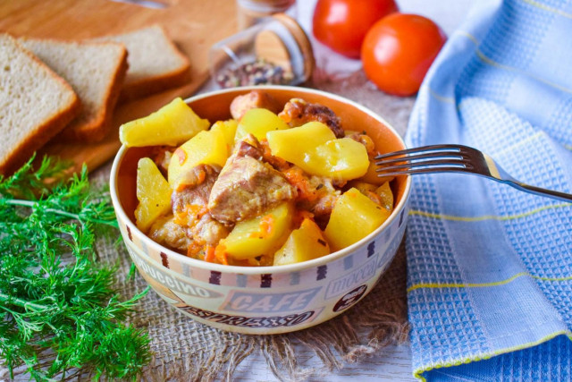 Roast pork with potatoes at home in a frying pan