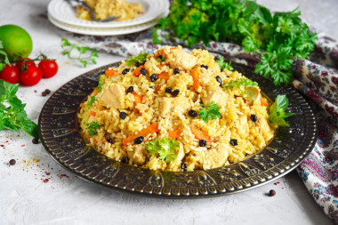 Pilaf on the stove in a cauldron of chicken