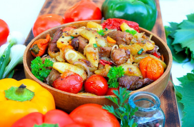 Potatoes with meat on a fire in a cauldron