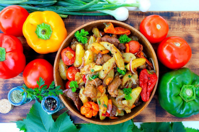 Potatoes with meat on a fire in a cauldron