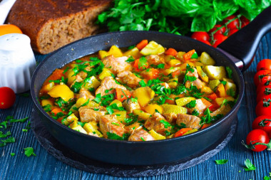 Pork stewed with vegetables in a frying pan