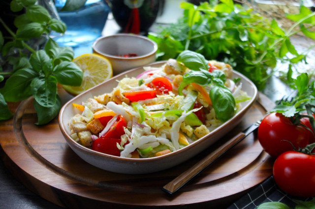 Peking cabbage salad with chicken croutons and tomatoes