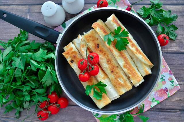 Lavash sausage cheese egg in a frying pan