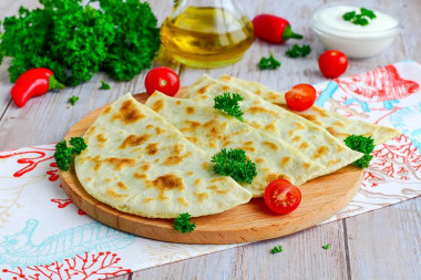 Thin tortillas in a frying pan made of dough with filling