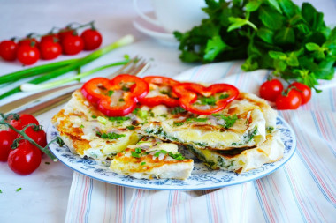 Fried eggs in pita bread in a frying pan with cheese