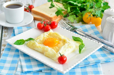 Breakfast of eggs and cheese in a frying pan