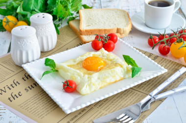 Breakfast of eggs and cheese in a frying pan