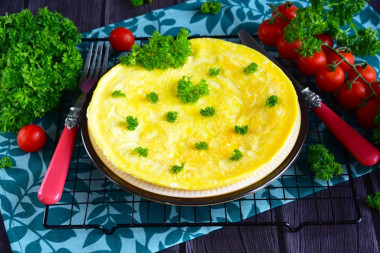 Classic omelet with milk in a frying pan