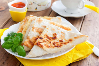 Pita bread sandwiches with cheese in a frying pan