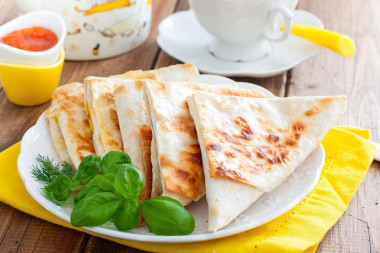 Pita bread sandwiches with cheese in a frying pan