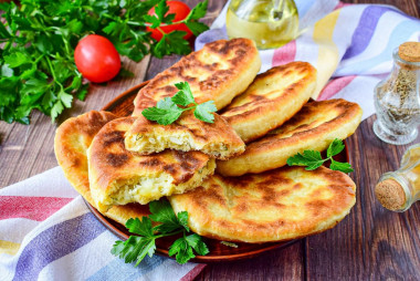 Thin pies with potatoes in a frying pan