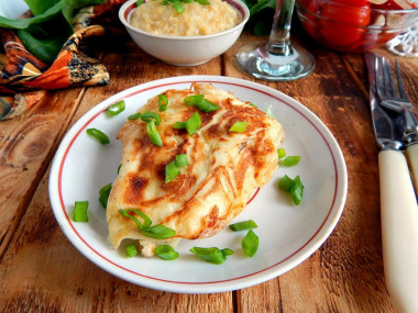 Pork chops in batter in a frying pan