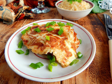 Pork chops in batter in a frying pan