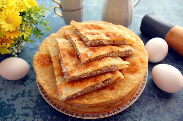 Tortillas with meat in a frying pan