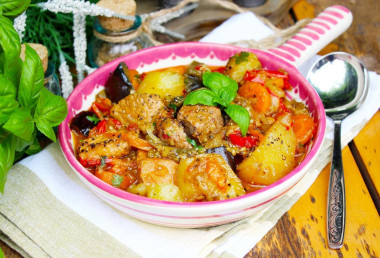 Vegetable stew in a cauldron with meat and potatoes on a campfire