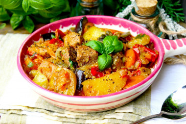 Vegetable stew in a cauldron with meat and potatoes on a campfire