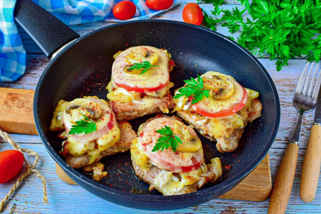 French-style meat in a frying pan with potatoes pork