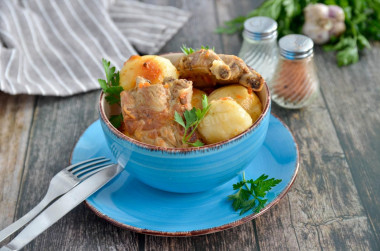 Pork ribs with potatoes in a cauldron