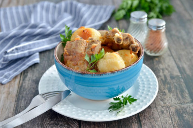 Pork ribs with potatoes in a cauldron