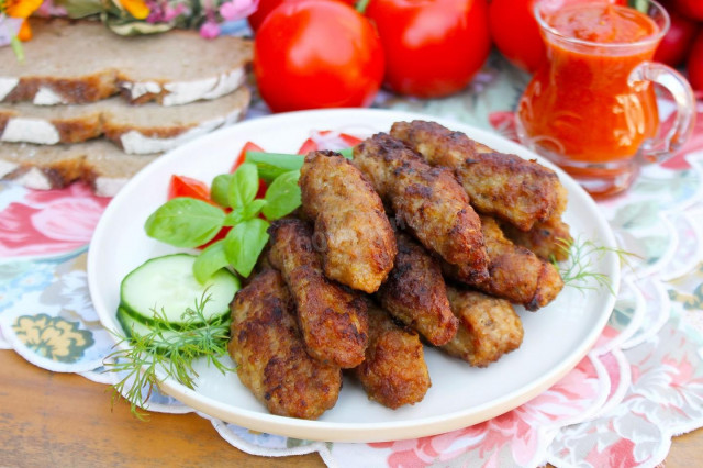 Chevapchichi sausages in a frying pan