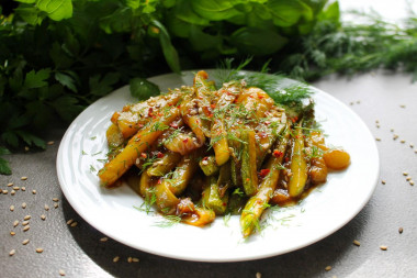 Zucchini with soy sauce and garlic in a frying pan