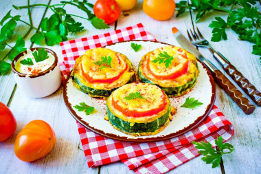 Zucchini with sausage and cheese in a frying pan