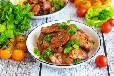 Pork meat in soy sauce in a frying pan