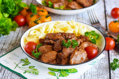 Pork meat in soy sauce in a frying pan