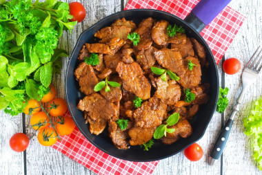 Pork meat in soy sauce in a frying pan