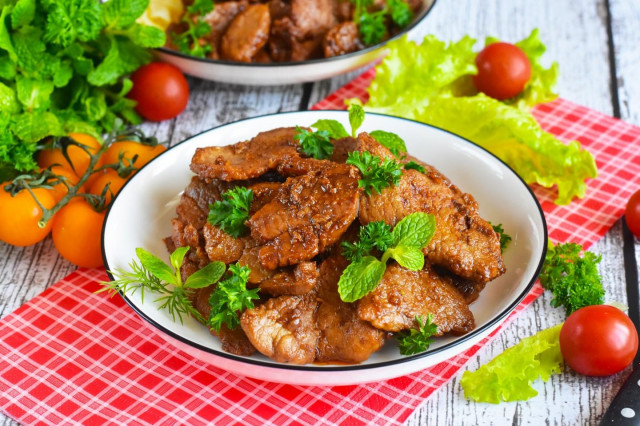 Pork meat in soy sauce in a frying pan