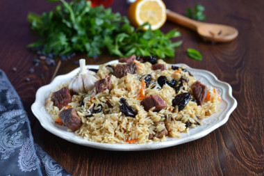 Pilaf with prunes in saucepan