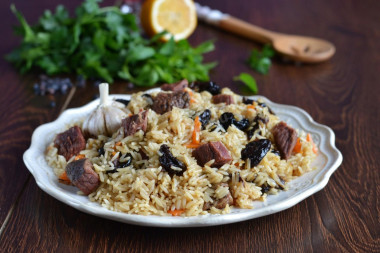 Pilaf with prunes in saucepan