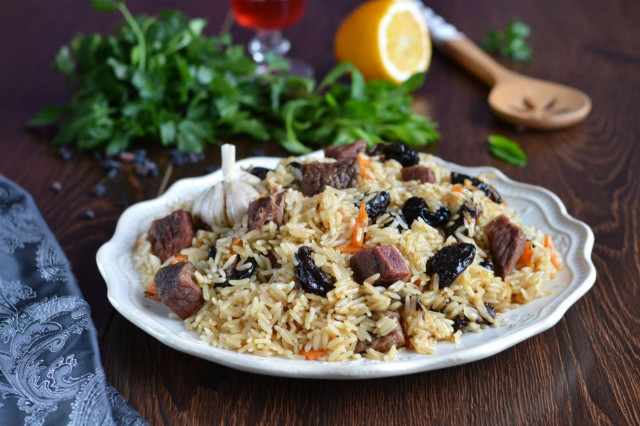 Pilaf with prunes in saucepan