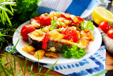 Fish with vegetables in a frying pan