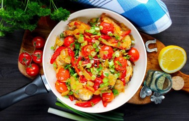 Fish with vegetables in a frying pan