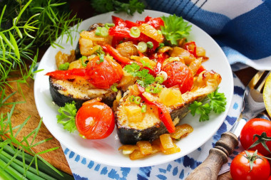 Fish with vegetables in a frying pan