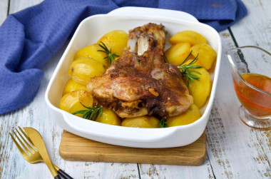 Pork knuckle baked with potatoes in the oven