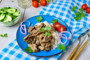 Chicken liver in a frying pan with mayonnaise