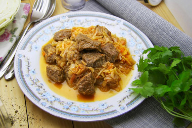 Stewed cabbage with meat in a saucepan