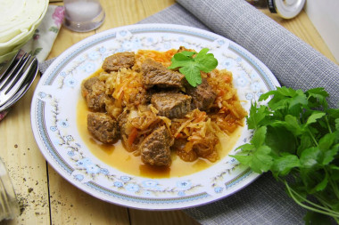 Stewed cabbage with meat in a saucepan